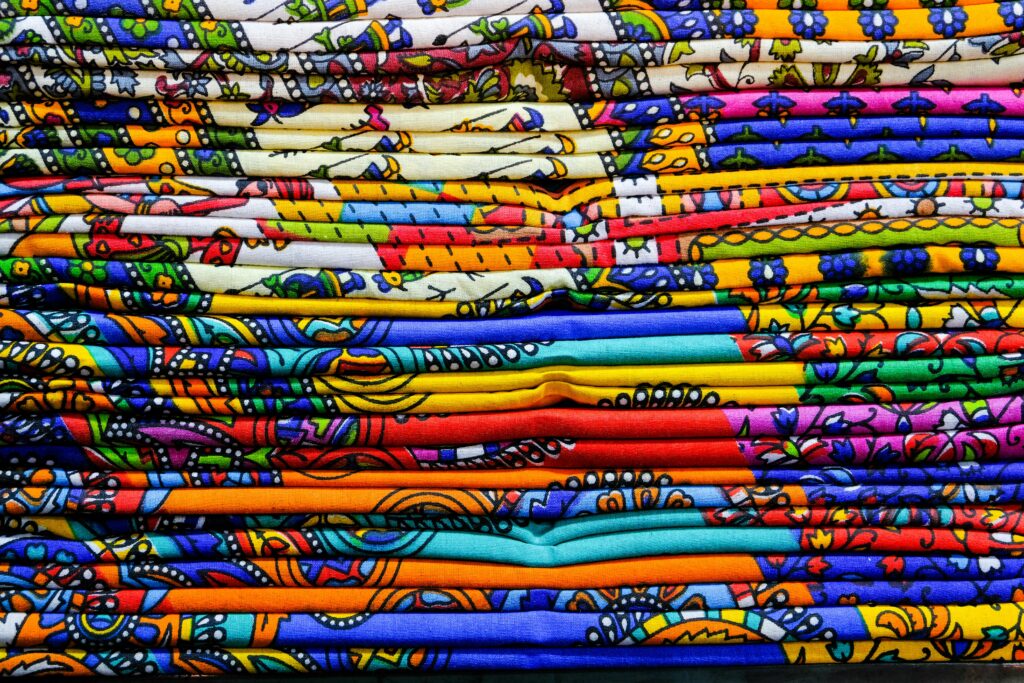 pexels-photo-4566670-4566670 Close-up of colorful Indian textiles showcasing traditional patterns in Jaipur, India.